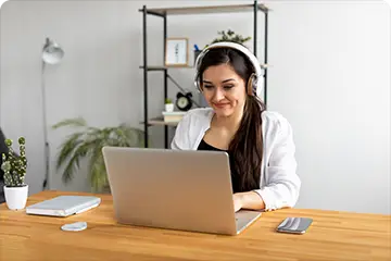 A girl attending a Montessori Teacher Training course on her laptop